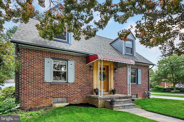 29 S Rockburn St, York, PA 17402 - view of front of home featuring a front lawn, brick siding, and a shingled roof