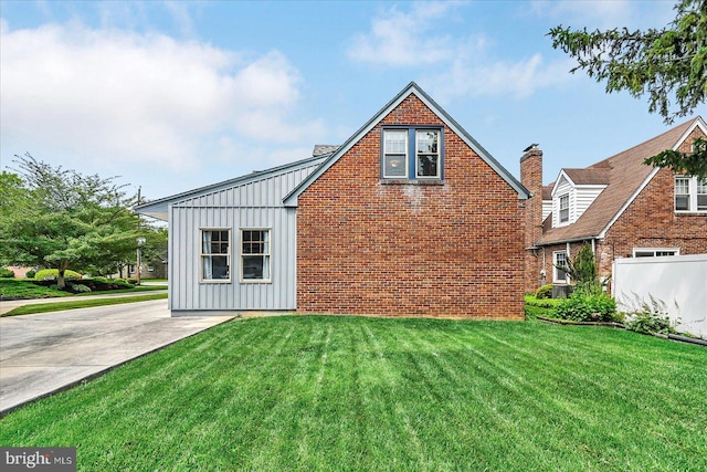 29 S Rockburn St, York, PA 17402 - view of home's exterior with board and batten siding, a yard, and brick siding