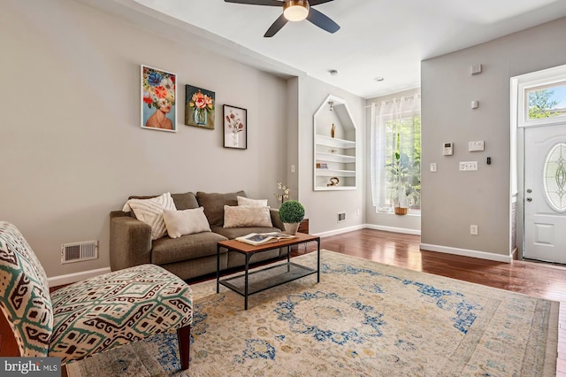 424 N Luzerne Ave N, Baltimore, MD 21224 - living room featuring wood finished floors, healthy amount of natural light, baseboards, and a ceiling fan