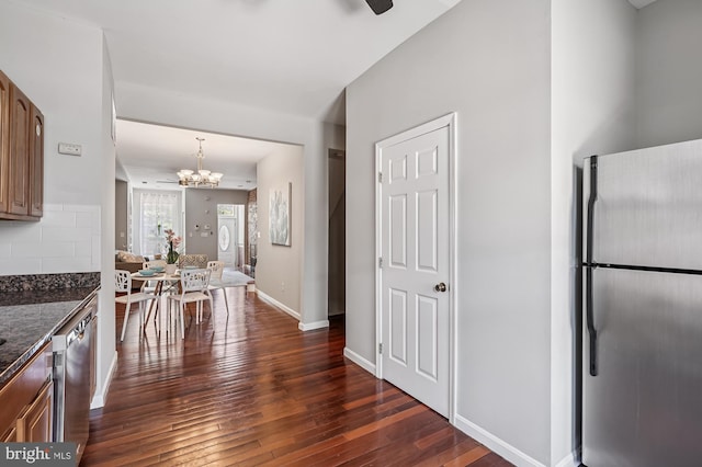 424 N Luzerne Ave N, Baltimore, MD 21224 - kitchen featuring stainless steel appliances, a chandelier, dark wood finished floors, tasteful backsplash, and baseboards