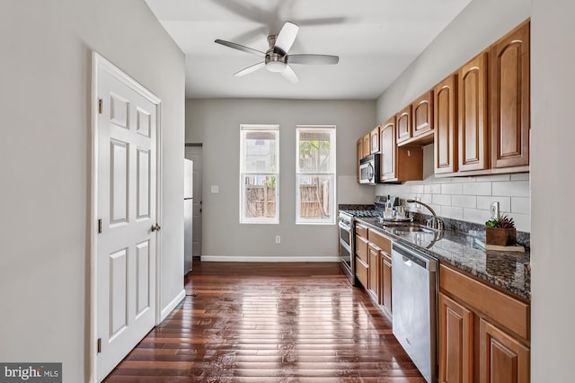424 N Luzerne Ave N, Baltimore, MD 21224 - kitchen featuring stainless steel appliances, a sink, ceiling fan, dark wood-style flooring, and decorative backsplash