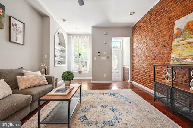 424 N Luzerne Ave N, Baltimore, MD 21224 - living room featuring brick wall, dark wood finished floors, baseboards, and ceiling fan