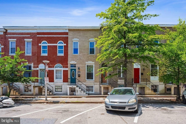 424 N Luzerne Ave N, Baltimore, MD 21224 - view of property featuring uncovered parking and brick siding