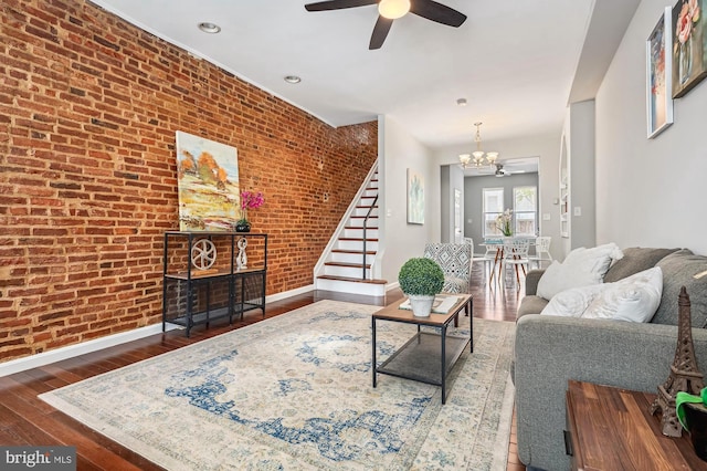 424 N Luzerne Ave N, Baltimore, MD 21224 - living area featuring a chandelier, baseboards, hardwood / wood-style flooring, stairs, and brick wall