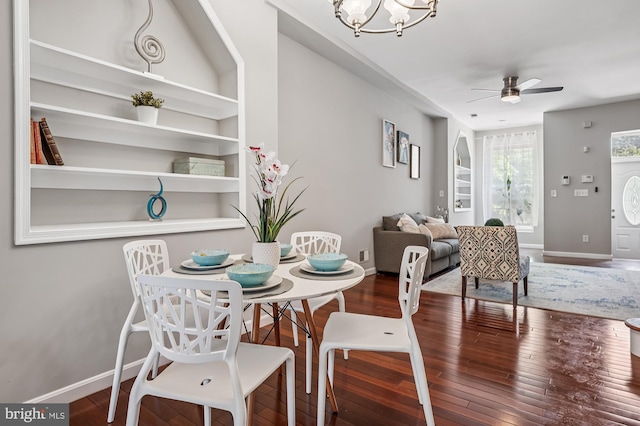 424 N Luzerne Ave N, Baltimore, MD 21224 - dining space with a ceiling fan, a chandelier, baseboards, and wood finished floors