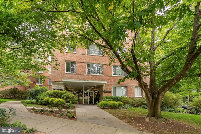 4100 W St NW Unit 314, Washington, DC 20007 - view of building exterior featuring a carport and driveway