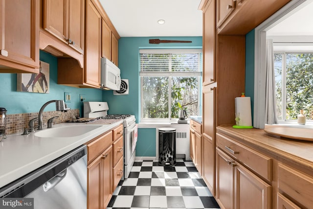 4100 W St NW Unit 314, Washington, DC 20007 - kitchen featuring white appliances, a sink, dark flooring, light countertops, and plenty of natural light