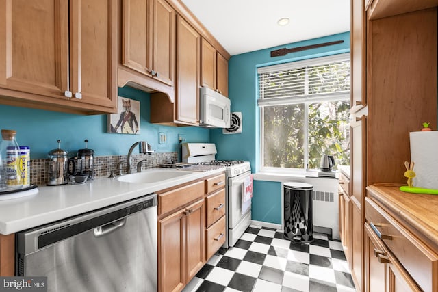 4100 W St NW Unit 314, Washington, DC 20007 - kitchen featuring white appliances, a sink, dark flooring, and light countertops