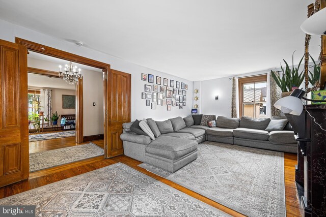 19 W Ave, Woodstown, NJ 08098 - living room featuring a chandelier, wood finished floors, and healthy amount of natural light