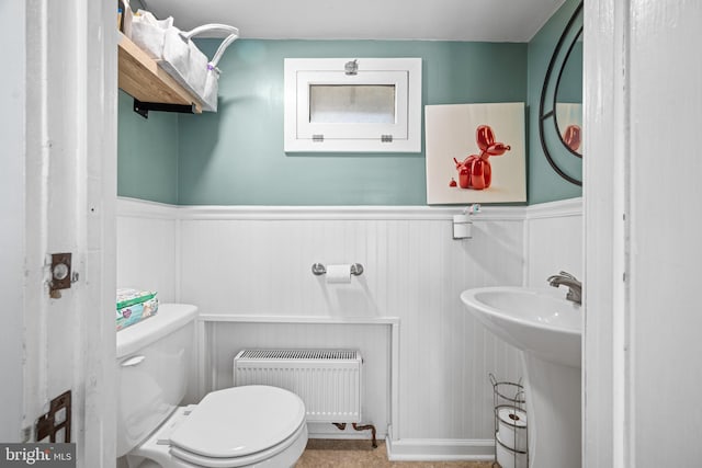 19 W Ave, Woodstown, NJ 08098 - half bath featuring radiator heating unit, wainscoting, toilet, and a sink