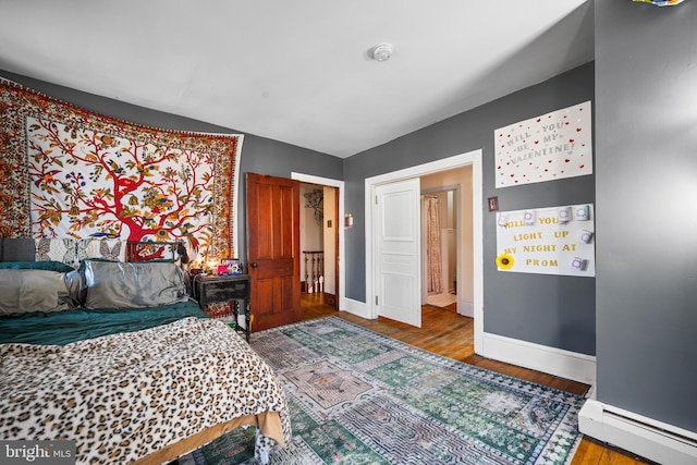 19 W Ave, Woodstown, NJ 08098 - bedroom featuring a baseboard heating unit, baseboards, and wood finished floors