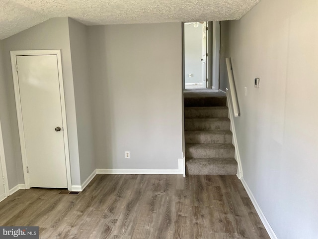 647 Elm St, Aberdeen, MD 21001 - stairway featuring a textured ceiling and wood finished floors