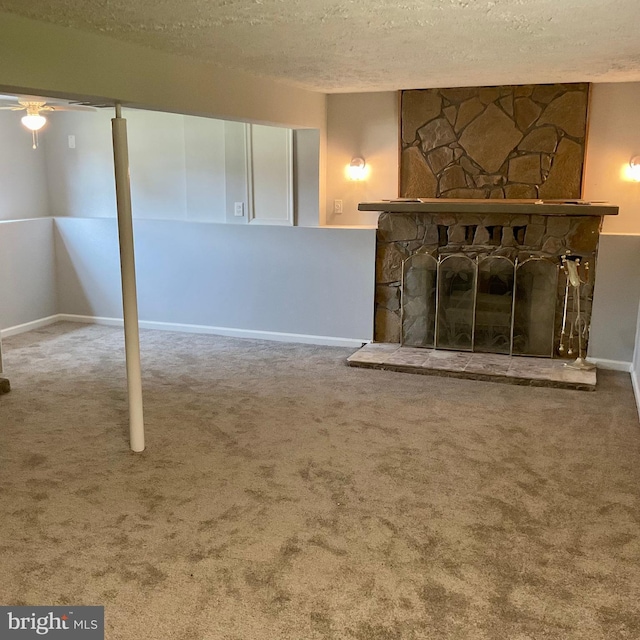 647 Elm St, Aberdeen, MD 21001 - below grade area featuring a textured ceiling, carpet, ceiling fan, and a stone fireplace