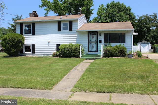 647 Elm St, Aberdeen, MD 21001 - tri-level home with a front yard, a chimney, and an outdoor structure