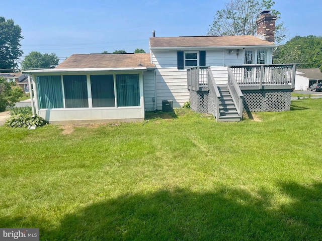 647 Elm St, Aberdeen, MD 21001 - rear view of house with a chimney, a deck, stairs, a sunroom, and a lawn