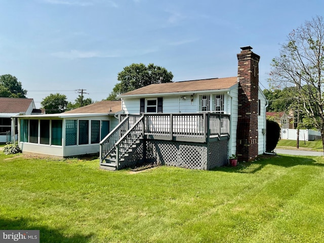 647 Elm St, Aberdeen, MD 21001 - rear view of house with a sunroom, a deck, a chimney, and a lawn