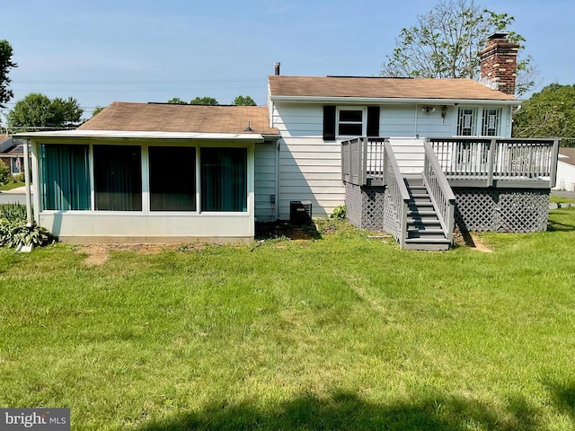 647 Elm St, Aberdeen, MD 21001 - back of property with a sunroom, a wooden deck, stairs, a chimney, and a yard
