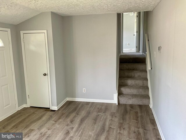 647 Elm St, Aberdeen, MD 21001 - stairway with a textured ceiling, wood finished floors, vaulted ceiling, and a ceiling fan