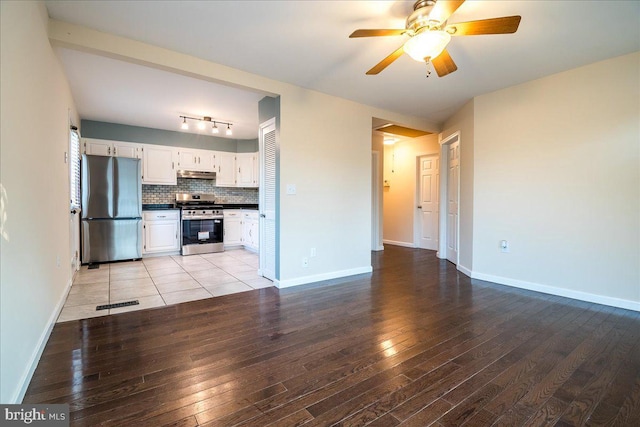 113 Wilgate Rd, Owings Mills, MD 21117 - kitchen featuring stainless steel appliances, light wood-type flooring, ceiling fan, dark countertops, and under cabinet range hood