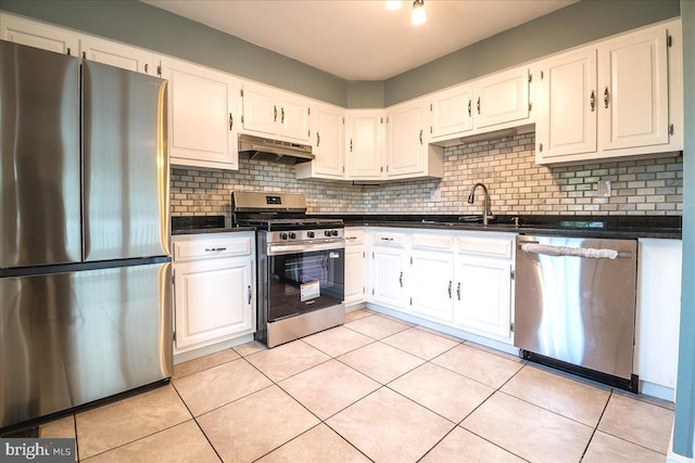 113 Wilgate Rd, Owings Mills, MD 21117 - kitchen featuring stainless steel appliances, under cabinet range hood, dark countertops, backsplash, and light tile patterned flooring