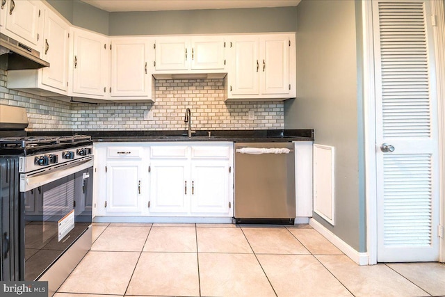 113 Wilgate Rd, Owings Mills, MD 21117 - kitchen featuring stainless steel appliances, dark countertops, white cabinetry, decorative backsplash, and a sink