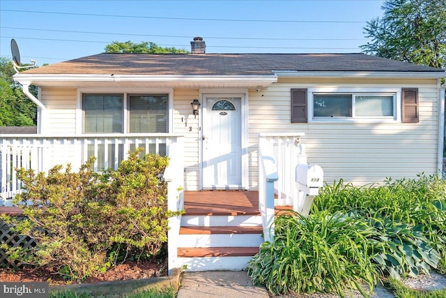 113 Wilgate Rd, Owings Mills, MD 21117 - bungalow-style house with a shingled roof and a chimney