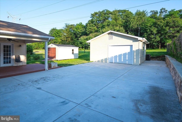 113 Wilgate Rd, Owings Mills, MD 21117 - detached garage with a ceiling fan, driveway, and view of scattered trees