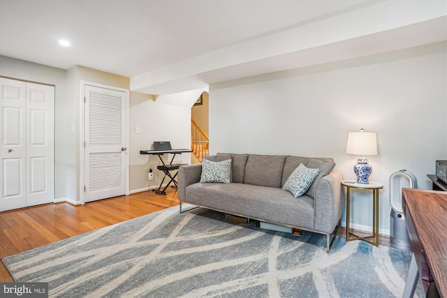 7484 Gadsby Sq, Alexandria, VA 22315 - living room featuring wood finished floors, stairs, baseboards, and recessed lighting