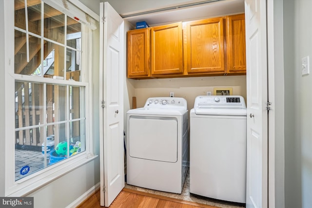 7484 Gadsby Sq, Alexandria, VA 22315 - laundry room with cabinet space, washer and dryer, light wood finished floors, and baseboards