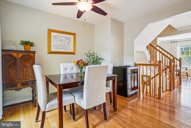 7484 Gadsby Sq, Alexandria, VA 22315 - dining room featuring beverage cooler, a ceiling fan, light wood finished floors, and stairway
