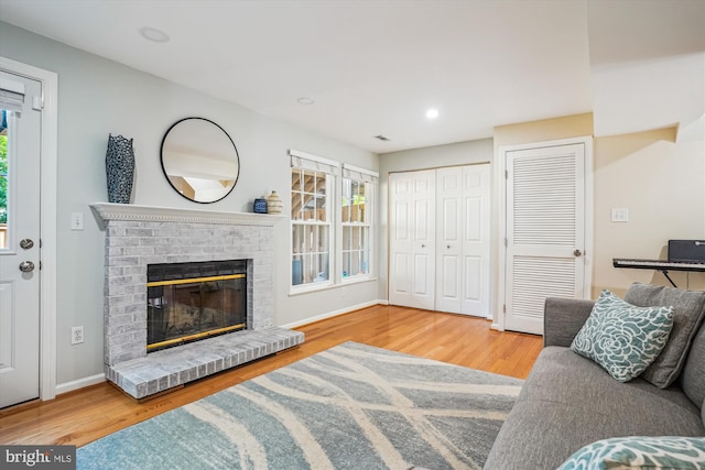 7484 Gadsby Sq, Alexandria, VA 22315 - living area featuring wood finished floors, a brick fireplace, baseboards, and recessed lighting