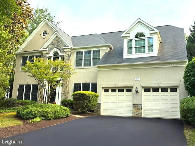 12691 Fox Woods Dr, Herndon, VA 20171 - view of front facade with stone siding, stucco siding, and asphalt driveway
