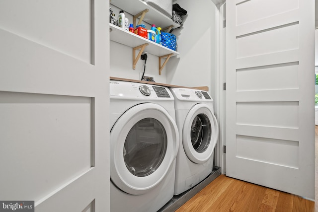 1401 S Carolina Ave SE Unit 1, Washington, DC 20003 - laundry area with washing machine and clothes dryer and light wood-style floors