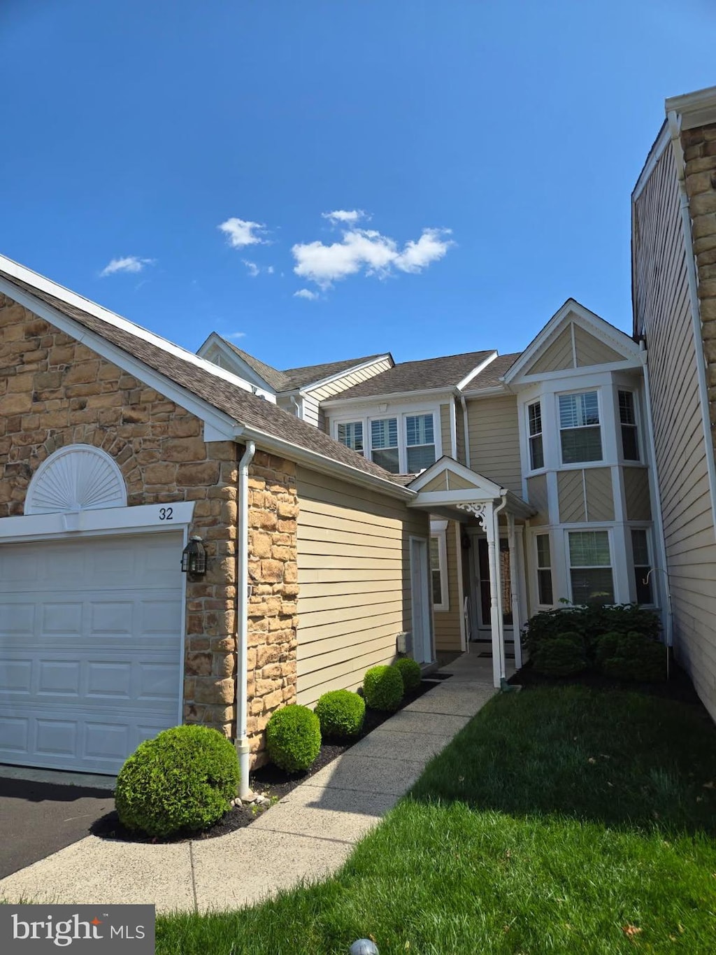 32 Hunters Way W, Newtown, PA 18940 - multi unit property featuring stone siding, an attached garage, and roof with shingles
