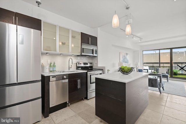 2311 M St NW Unit Ph-1007, Washington, DC 20037 - kitchen with stainless steel appliances, light countertops, a sink, backsplash, and a center island