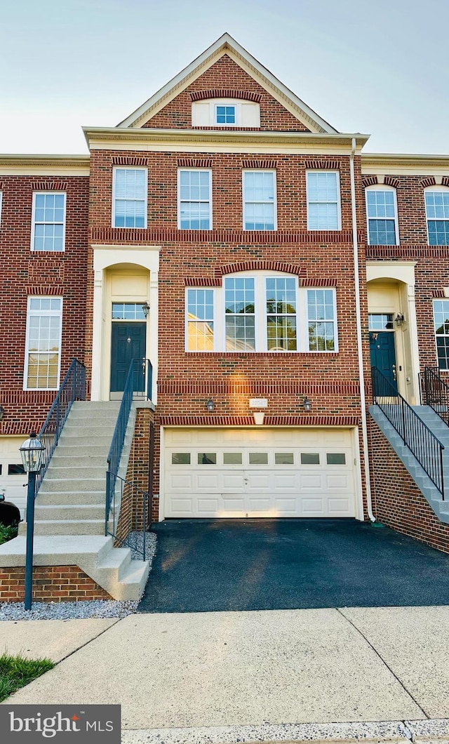 22047 Avonworth Sq, Broadlands, VA 20148 - view of front facade featuring asphalt driveway, a garage, and brick siding