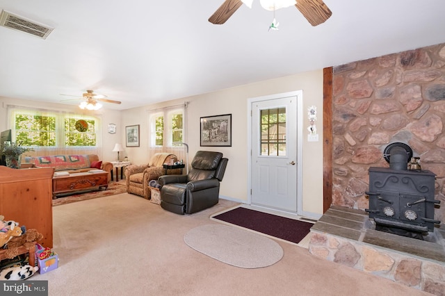 1214 Minnich Rd, Mechanicsburg, PA 17055 - living room with ceiling fan, a wood stove, and carpet
