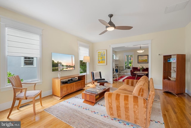 2811 35th St NW, Washington, DC 20007 - living area with light wood finished floors, a ceiling fan, and baseboards