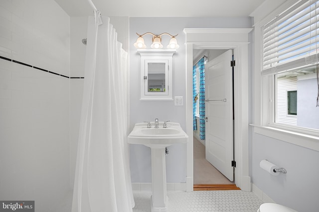 2811 35th St NW, Washington, DC 20007 - full bathroom featuring a shower with curtain, toilet, tile patterned flooring, and baseboards