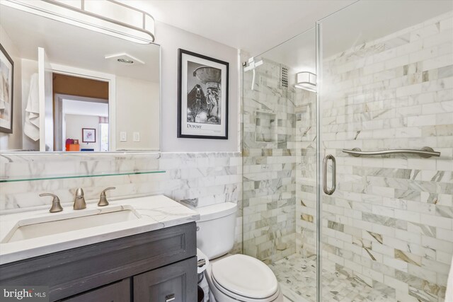 3001 Veazey Ter NW Unit 1632, Washington, DC 20008 - full bathroom with a shower stall, vanity, toilet, and tile walls