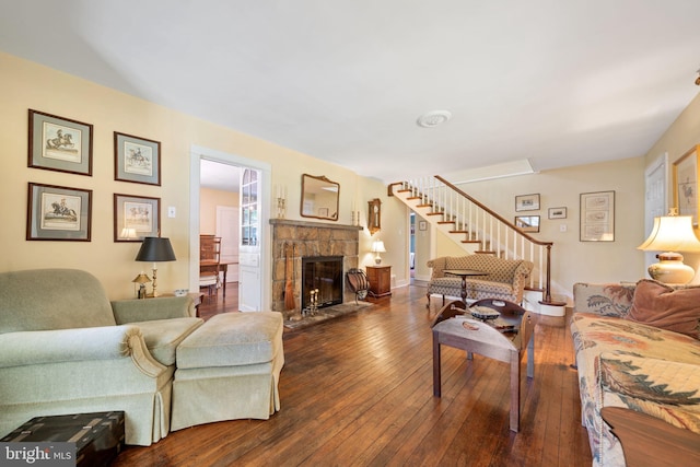 1033 Lenape Rd, West Chester, PA 19382 - living area with dark wood-style flooring, a stone fireplace, and stairway