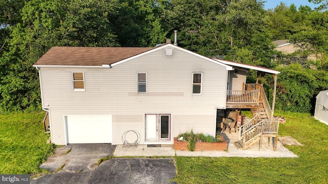 6085 Mud Mill Rd, Camden Wyoming, DE 19934 - back of property with stairway, an attached garage, a lawn, a wooden deck, and a patio