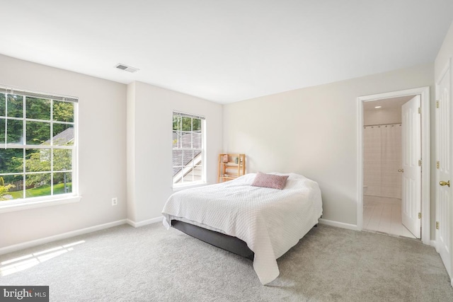 18525 Rushbrooke Dr, Olney, MD 20832 - carpeted bedroom featuring multiple windows, baseboards, and connected bathroom
