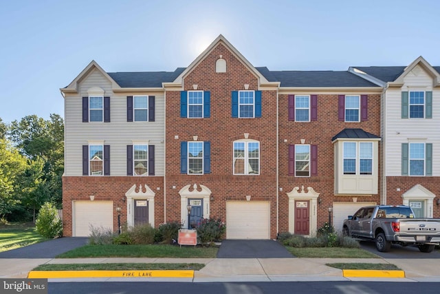 22864 Chestnut Oak Ter, Sterling, VA 20166 - view of property with brick siding, an attached garage, and driveway