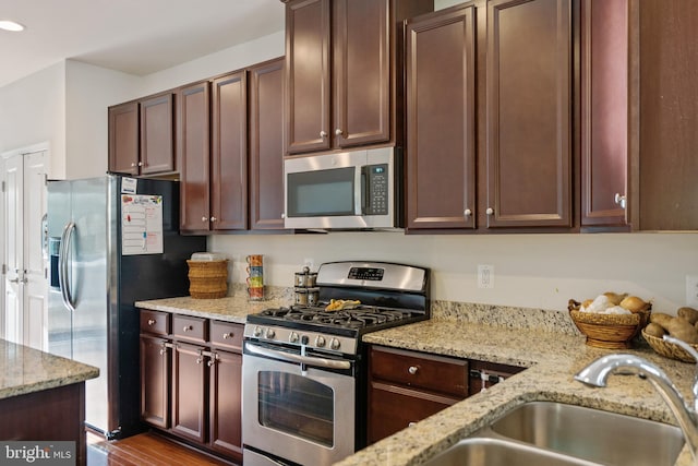22864 Chestnut Oak Ter, Sterling, VA 20166 - kitchen with stainless steel appliances, a sink, light stone countertops, and recessed lighting