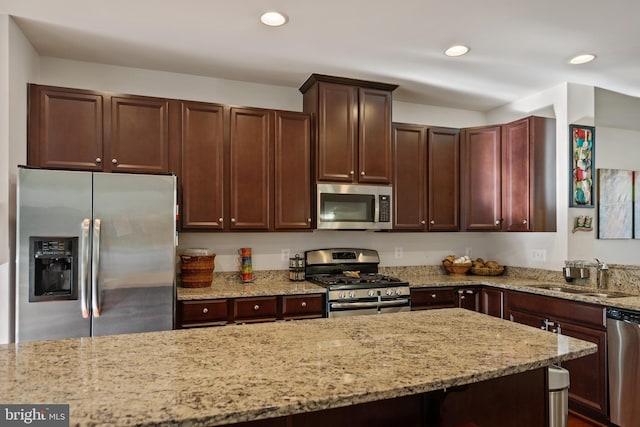 22864 Chestnut Oak Ter, Sterling, VA 20166 - kitchen with appliances with stainless steel finishes, a sink, light stone counters, recessed lighting, and dark brown cabinets
