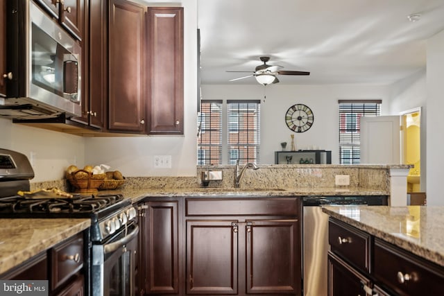 22864 Chestnut Oak Ter, Sterling, VA 20166 - kitchen featuring stainless steel appliances, a sink, a ceiling fan, a peninsula, and healthy amount of natural light