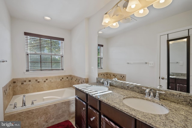 22864 Chestnut Oak Ter, Sterling, VA 20166 - bathroom featuring plenty of natural light, a garden tub, double vanity, and recessed lighting