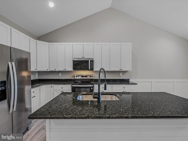 39 Mdg, Berkeley Springs, WV 25411 - kitchen with appliances with stainless steel finishes, a sink, vaulted ceiling, dark stone counters, and white cabinetry