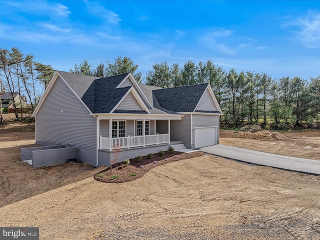 39 Mdg, Berkeley Springs, WV 25411 - view of front of house featuring a porch, concrete driveway, an attached garage, and a shingled roof
